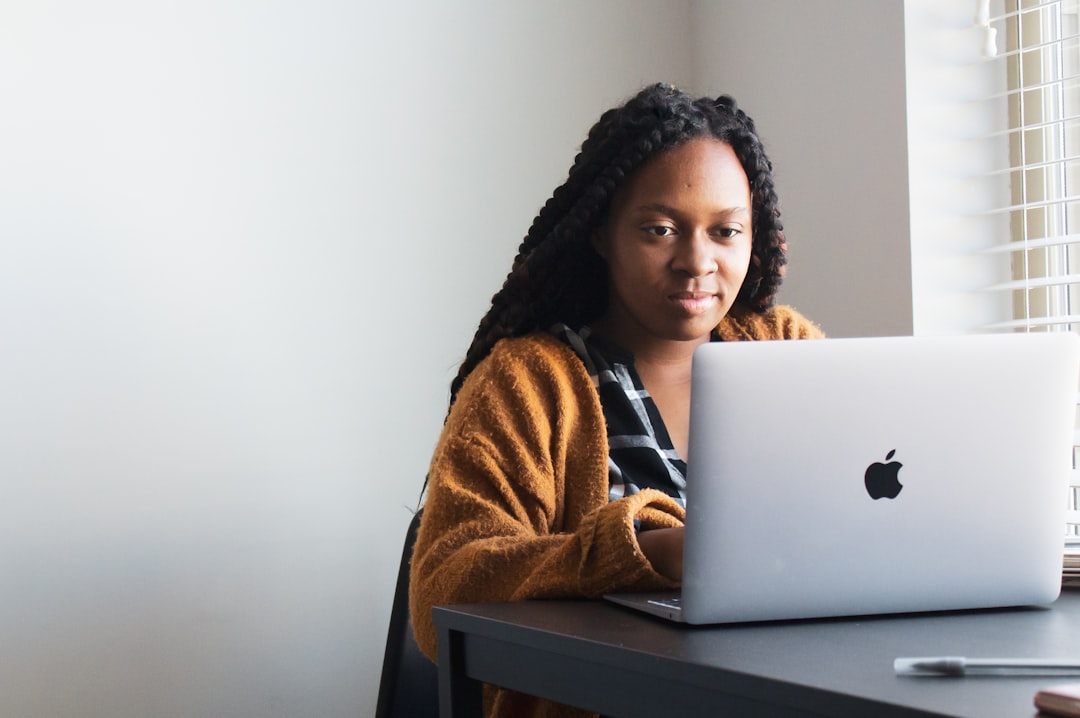 Black woman learning digital skills on a laptop